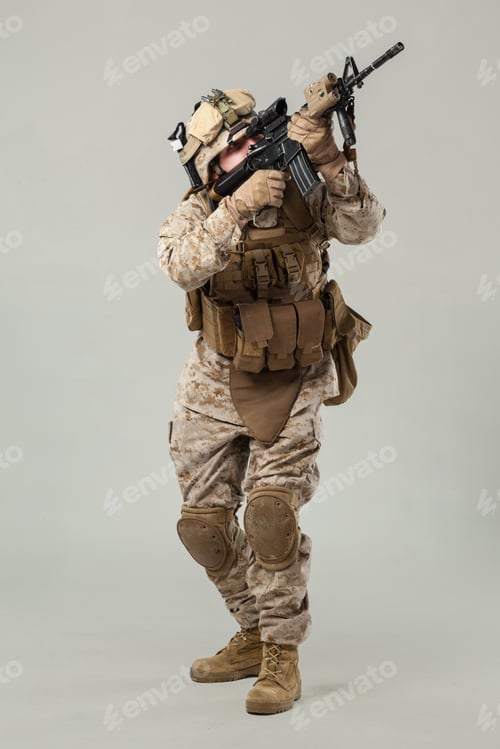 Preview: Soldier in combat gear poses with weapon during training session in a studio setting