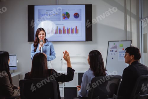Preview: Businesswoman asking question during presentation meeting in modern office