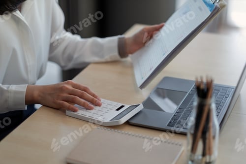 Preview: Close up a woman working about financial with calculator at her office to calculate expenses