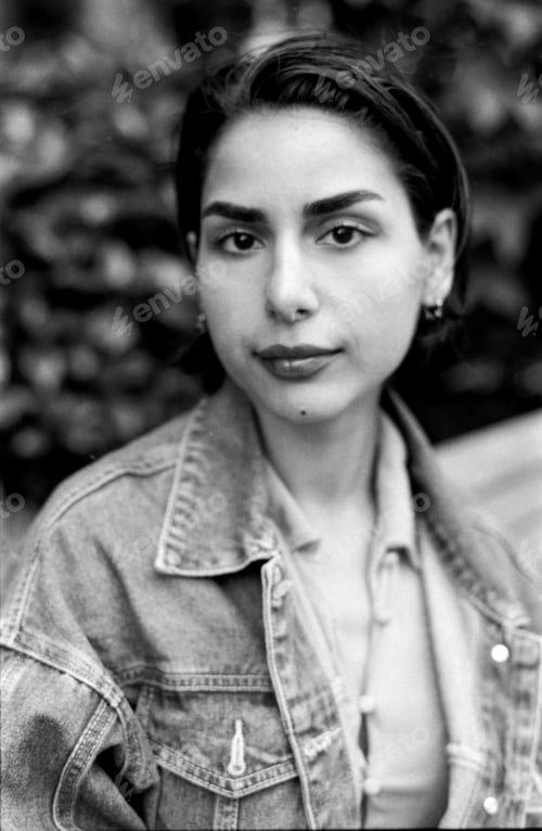 Preview: Young woman posing with denim jacket in monochrome analog portrait