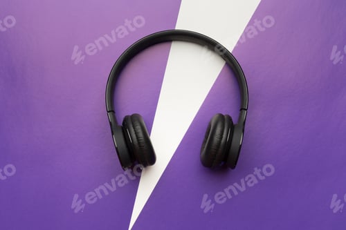Preview: Black headphones placed on a purple background with a white shape