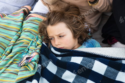 Preview: Young boy resting under blanket, De Kelders, Western Cape, South Africa.