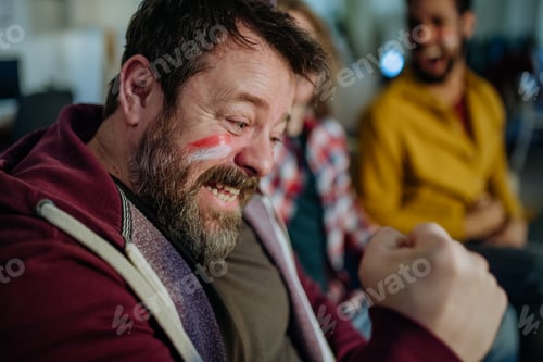 Preview: Happy Austrian football fans friends watching football at home and celebrating
