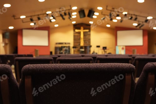Preview: Empty chairs facing cross and worship stage in church