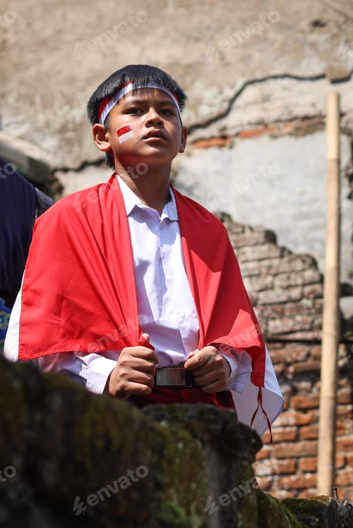Preview: Young elementary student looking away wear Indonesian flag using face painting and head band