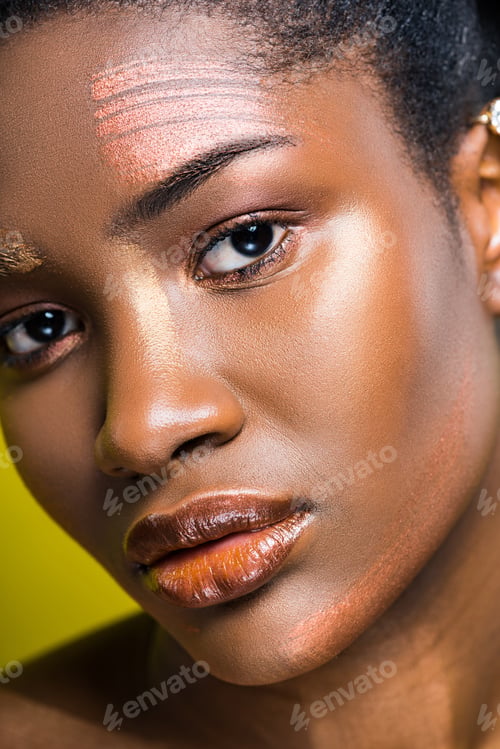 Preview: Sad african american young woman looking at camera on yellow