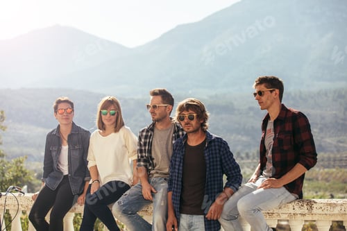 Preview: Stylish people sitting on stone railings
