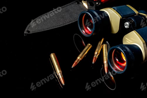 Preview: Military binoculars and cartridges on mirror background