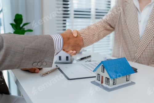 Preview: Two people in business attire finalize a real estate deal