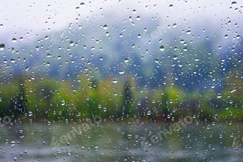Preview: Lake view through window in rainy day
