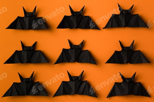 Preview: halloween texture with black origami bats, isolated on orange