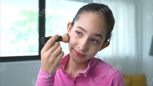 Preview: A girl ballet student in pink tracksuit use blush to put on makeup before performing ballet