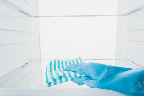 Preview: Cropped view of woman in rubber glove cleaning fridge shelf isolated on white