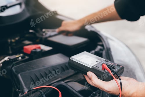 Preview: The car mechanic is carrying a battery meter and checking the general condition of the engine.