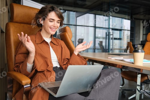 Preview: Portrait of surprised woman looks amazed at laptop screen, reacts to wonderful news brought up