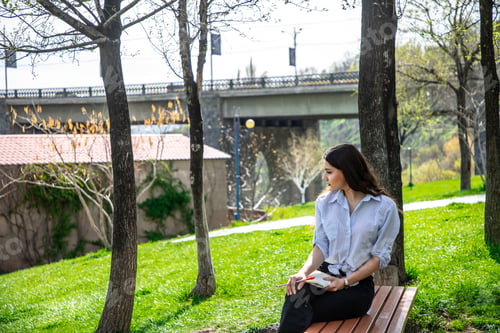 Preview: Girl studying in a park