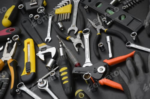 Preview: Handyman tool kit on black wooden table. Many wrenches and screwdrivers