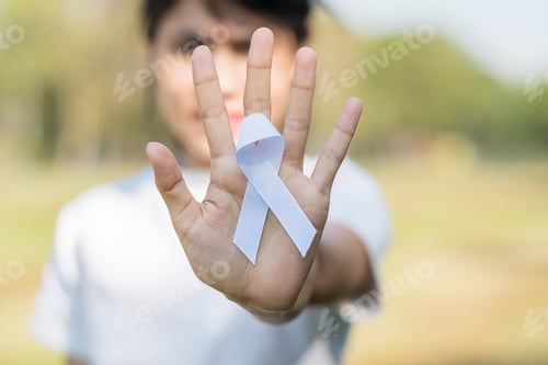 Preview: November Lung Cancer Awareness month. international peace day. Hand holding white Ribbon
