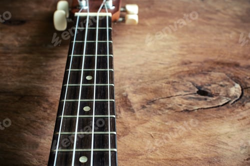 Preview: Close up of ukulele on old wood background