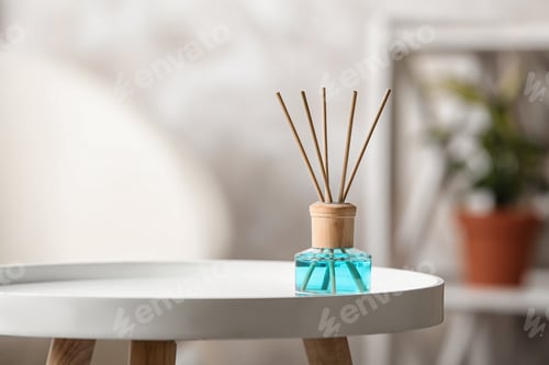 Preview: Reed air freshener on white table indoors, space for text