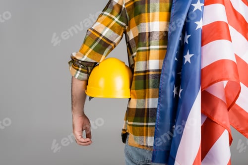 Preview: back view of cropped workman with hardhat and usa flag isolated on grey, labor day concept