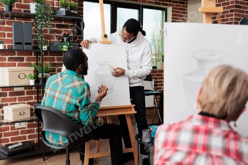Preview: Young painter teacher helping student with drawing process during art class