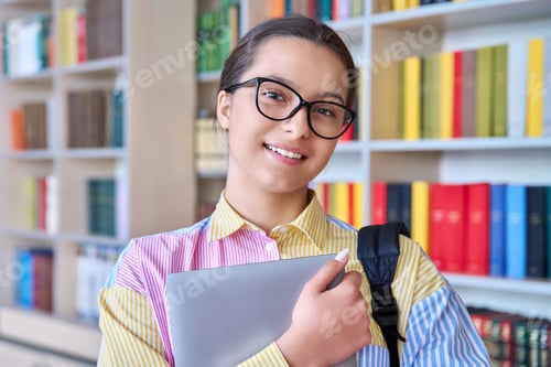 Preview: Portrait of high school student looking at camera in library