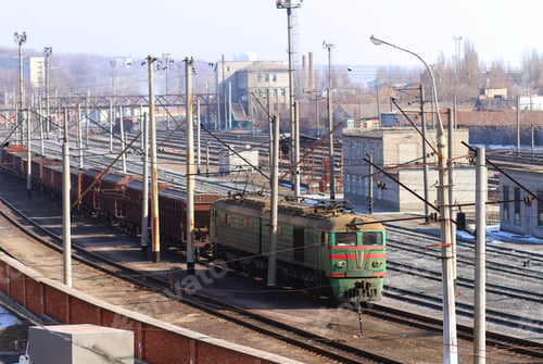 Preview: The only way to travel in the city. Shot of a train on the tracks with industry in the background.