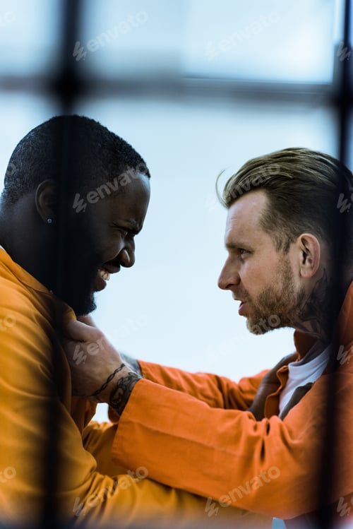 Preview: side view of multiethnic prisoners threatening each other and holding collars