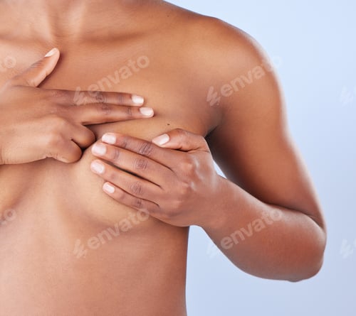 Preview: Studio shot of an unrecognisable woman examining her breast