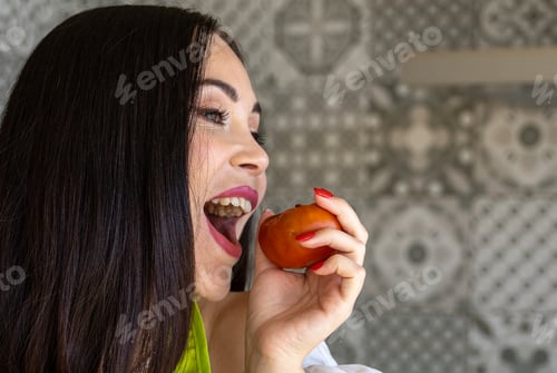 Preview: Brunette pretending to bite tomato