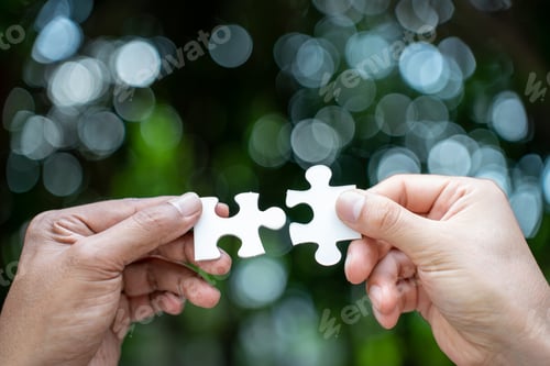 Preview: team hand power full hand placing the jigsaw puzzle piece for conect business partner and connection