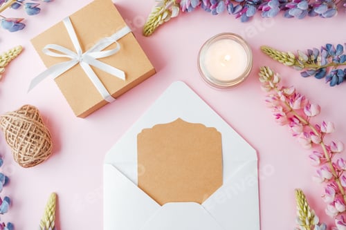 Preview: Gift box and envelope with card and flowers on pink background