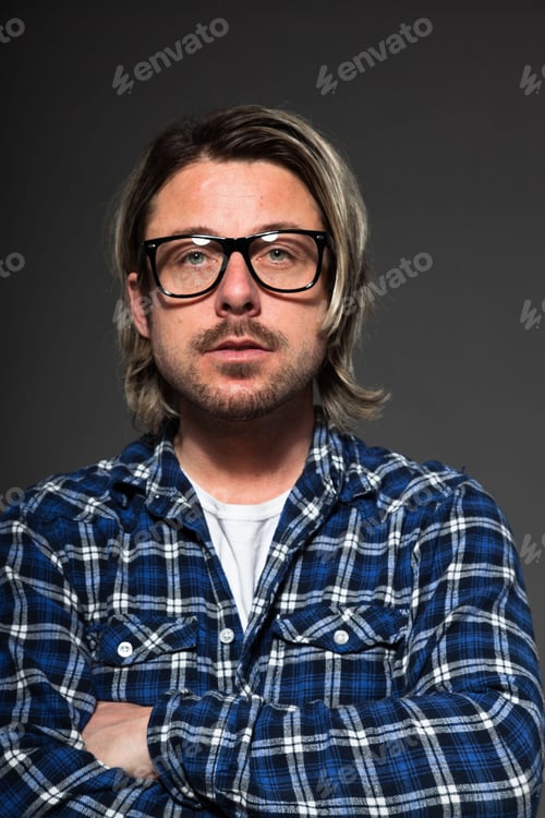 Preview: Expressive Young Man With Blond Long Hair And Beard. Studio Portrait Isolated On Grey Background.