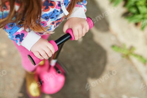 Preview: Cropped high angle view of girl on scooter