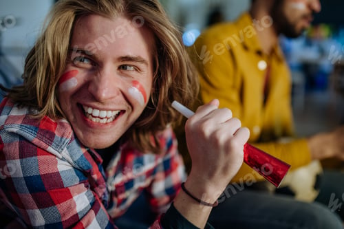 Preview: Happy Austrian football fans friends watching football at home and celebrating