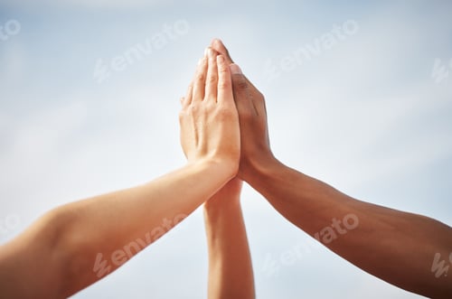 Preview: Cropped shot of three unrecognizable athletes high fiving while standing out on the track