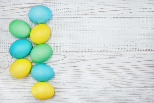 Preview: Colored eggs on a white wooden background. The concept of Easter and spring.