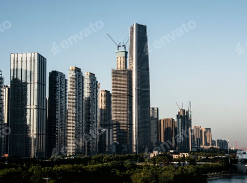 Preview: City skyline with high-rise buildings under construction on a clear day.