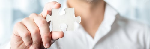 Preview: Businessman Holding Jigsaw Puzzle Piece