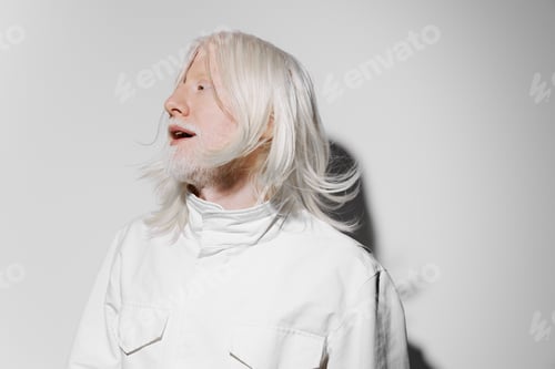 Preview: Portrait of an individual with white hair, wearing a minimalistic white outfit against a light gray