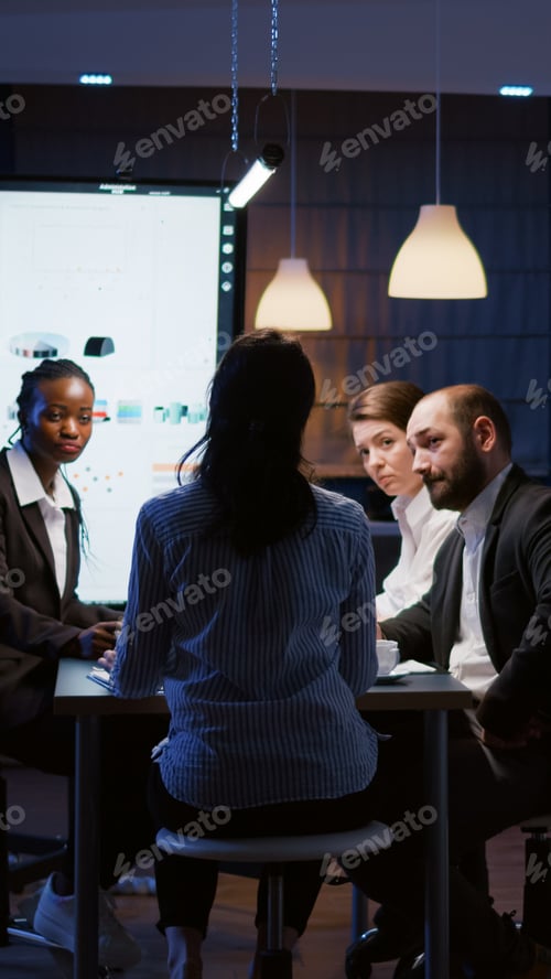 Preview: Selective focus of workaholic businesswoman back discussing financial graphs