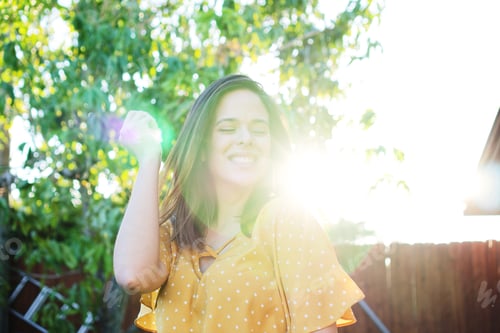 Preview: Happy woman smiling in the sunshine