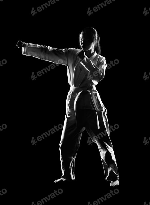 Preview: Full-Length Silhouette Portrait Of Beautiful Martial Arts Girl In Kimono Exercising Karate Kata On