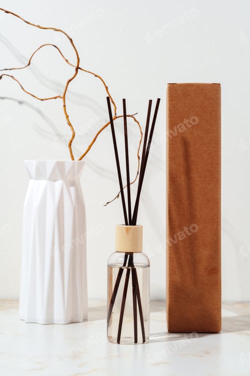 Preview: Reed Diffuser Bottle With Wooden Sticks on White Tabletop