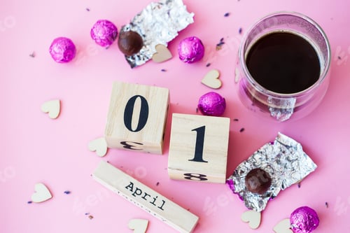 Preview: Hi spring. Wooden calendar with date 1 April, on pink background. World laughing day