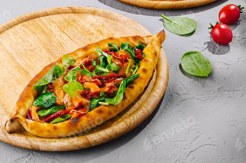 Preview: turkish pide lying on wooden boards