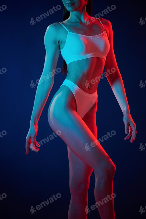 Preview: White underwear. Young woman is in the studio with neon lights