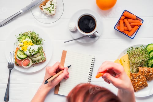 Preview: Morning habits of successful people. Day planning and healthy meal. Woman eating carrot and writing