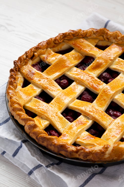 Preview: Yummy Homemade Cherry Pie on a white wooden surface, low angle view. Close-up.